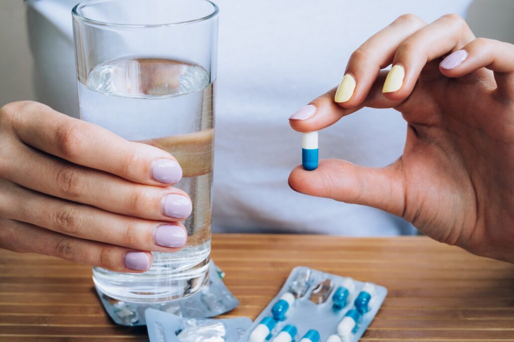 patient holding a diabetes pill