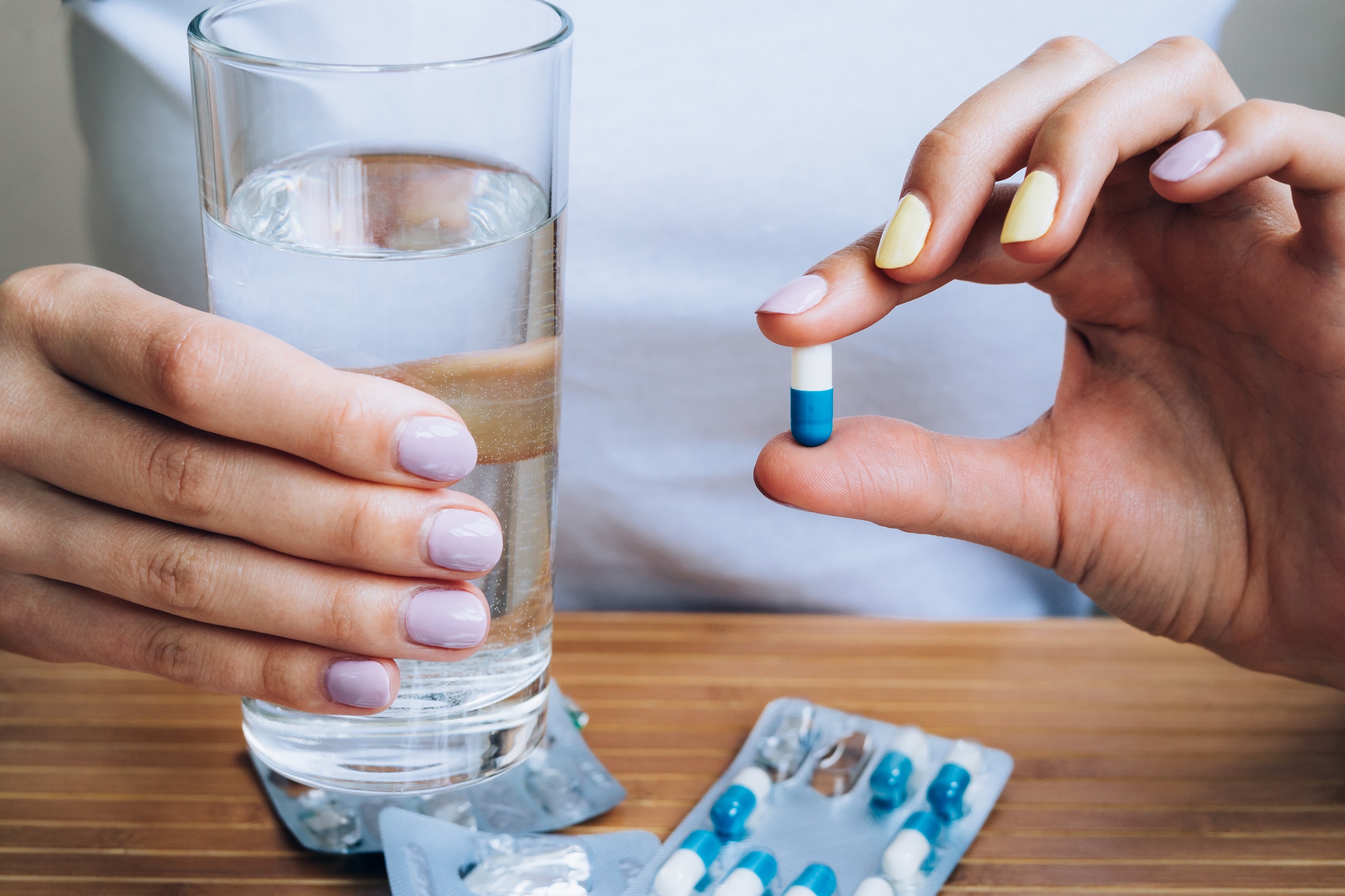 patient holding a diabetes pill