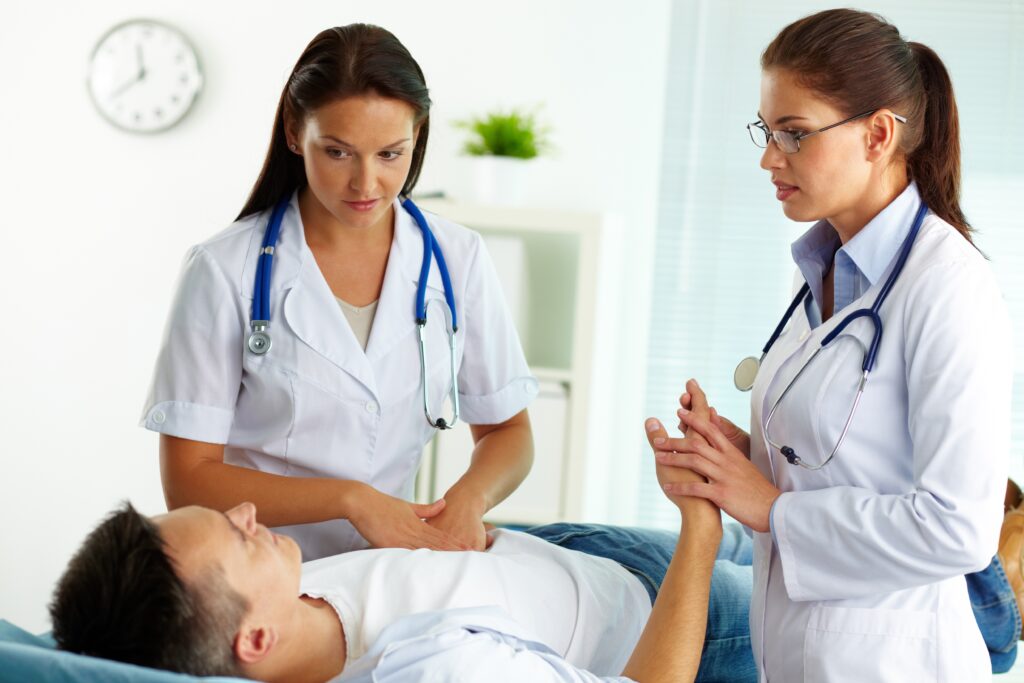 confident female doctors during medical treatment of patient in hospital