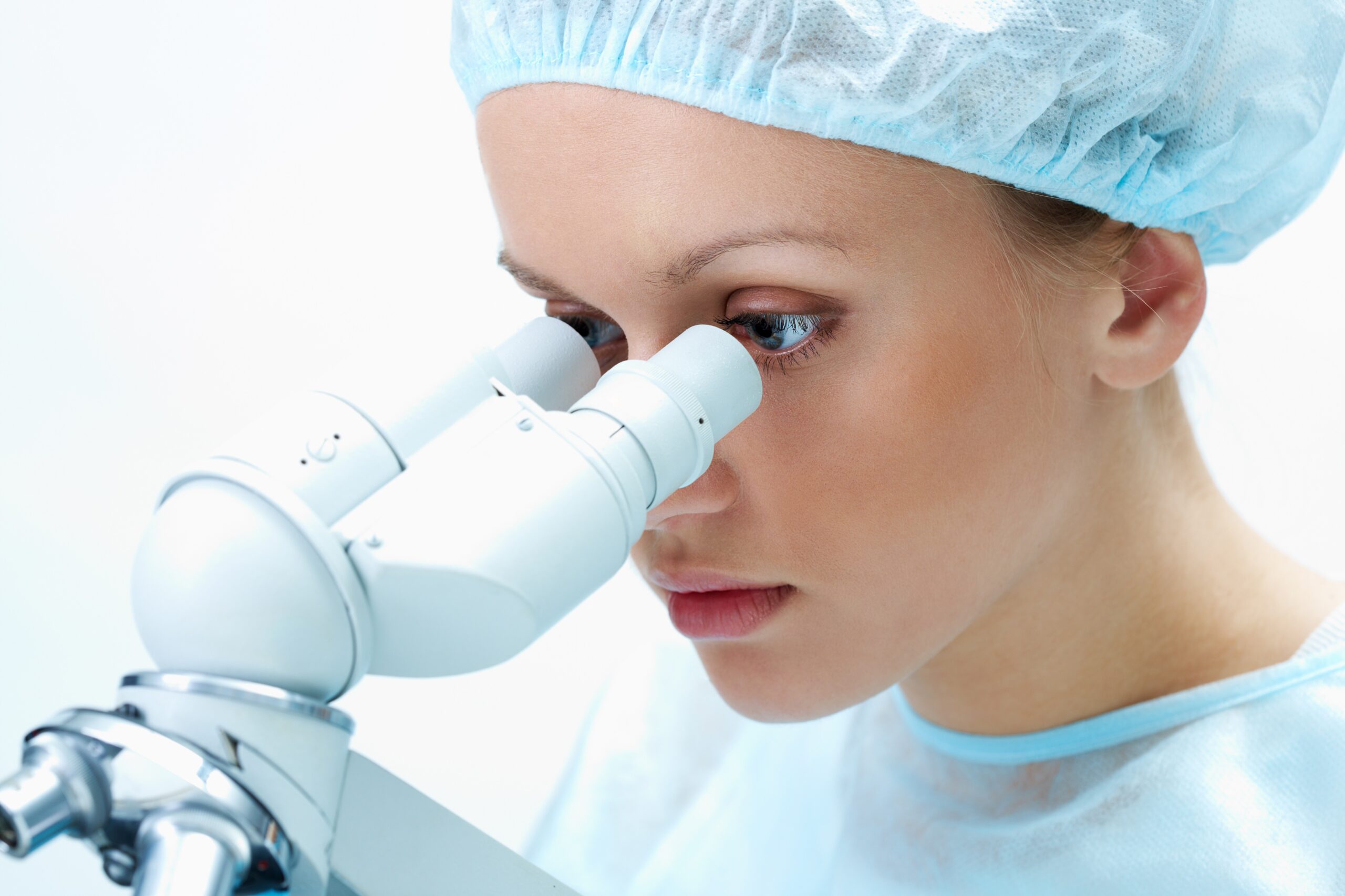 medical student looking through microscope in laboratory